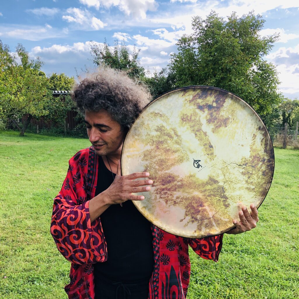 Om Shira playing drums in the nature